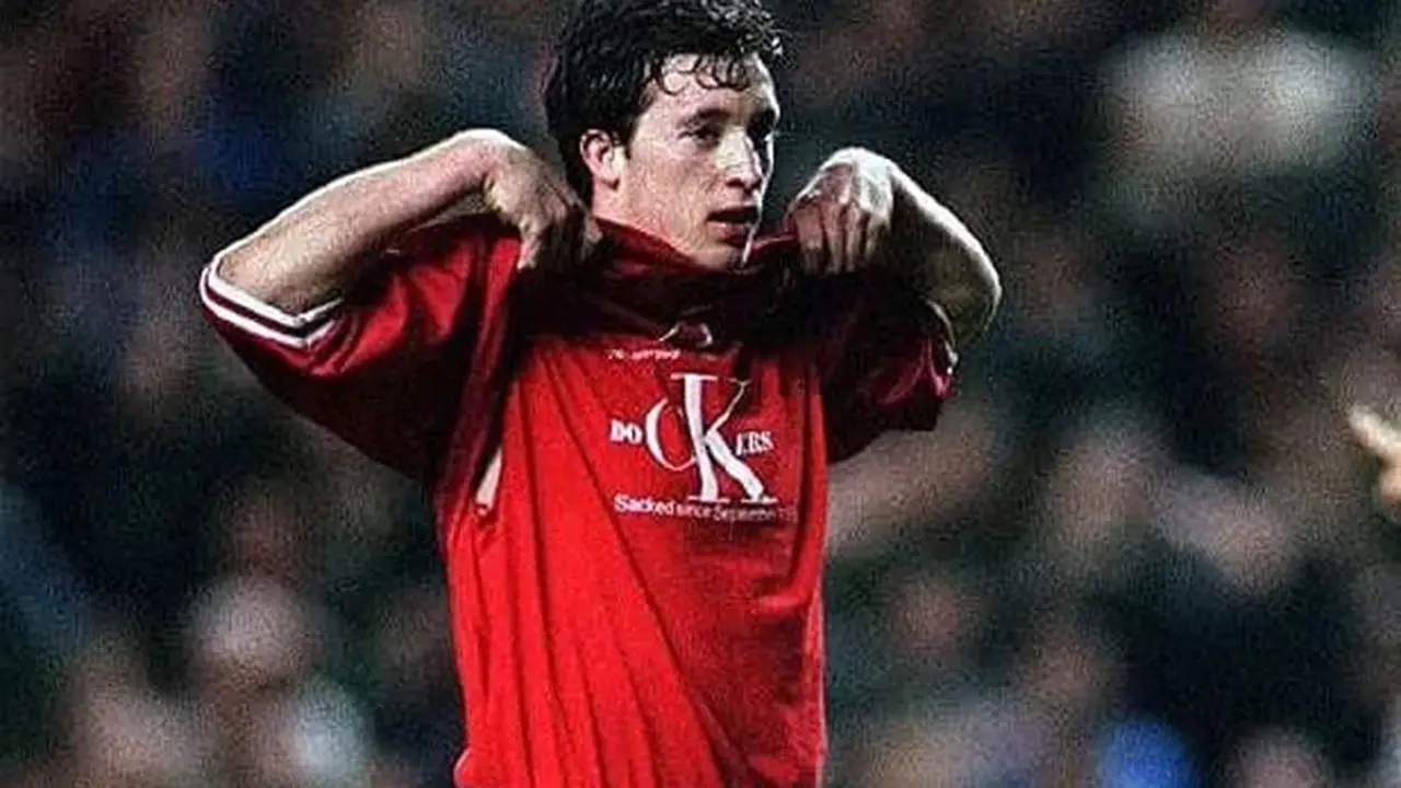 Robbie Fowler exposes the message on his t-shirt