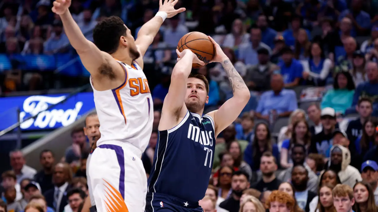 Luka Doncic shoots over Devin Booker