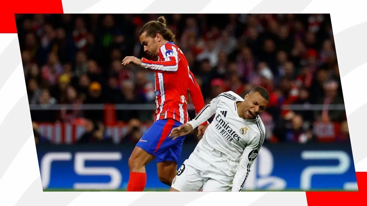 Real Madrid and Atletico Madrid players challenging for the ball
